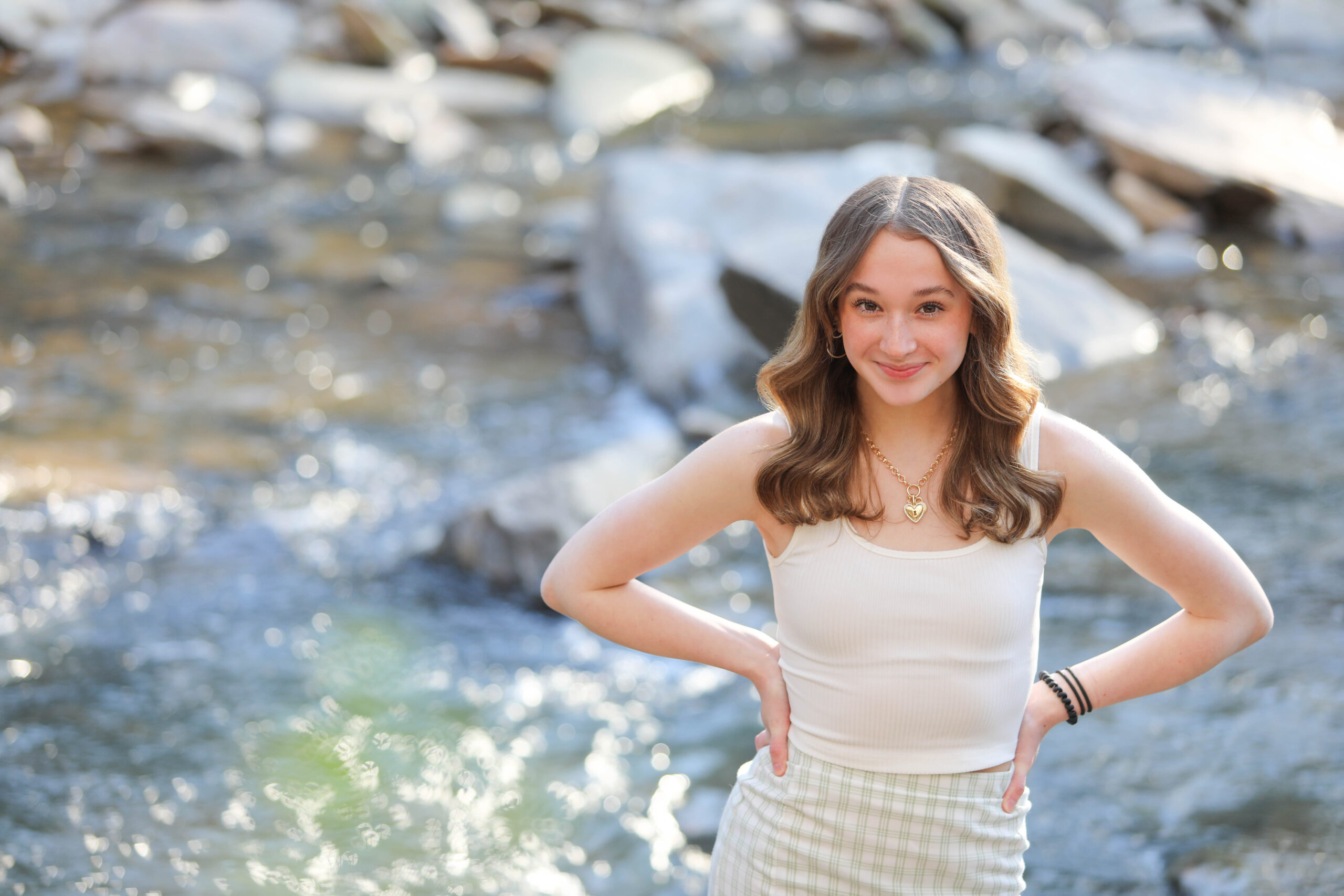 Portrait of a confident tween girl smiling during a 'Bloom Your Own Way' photo session. The image captures her radiant personality and self-assuredness, highlighting the beauty of celebrating individuality and inner strength before middle school.