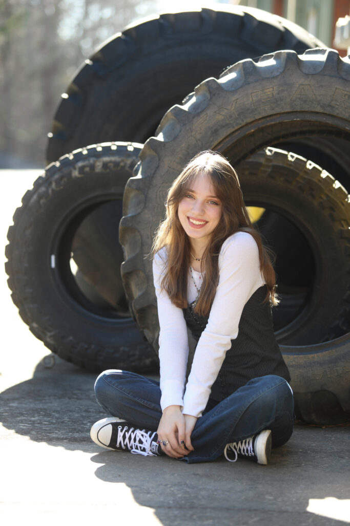 Portrait of a confident tween girl smiling during a 'Bloom Your Own Way' photo session. The image captures her radiant personality and self-assuredness, highlighting the beauty of celebrating individuality and inner strength before middle school