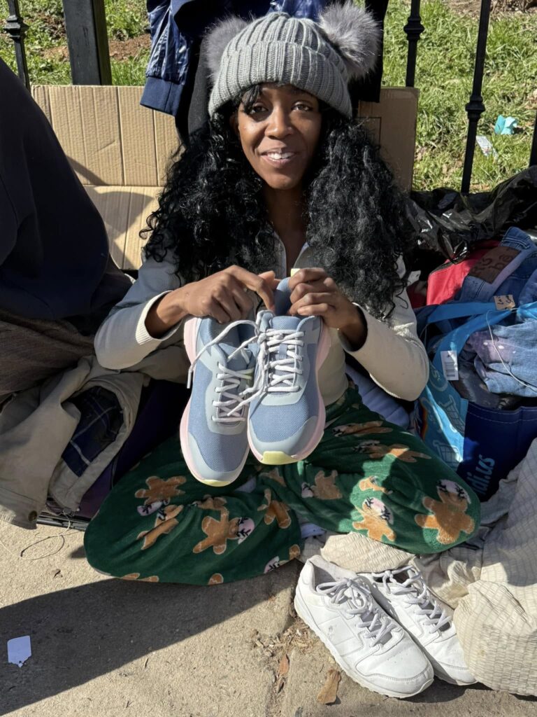 Lady living on the streets is so excited about her new shoes! 